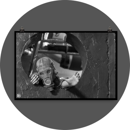 un4rt - black and white photographie of a mannequin wearing a gas mask and climbing through a round hole in a wall. the mannequin stretches out one arm and reaches for help.