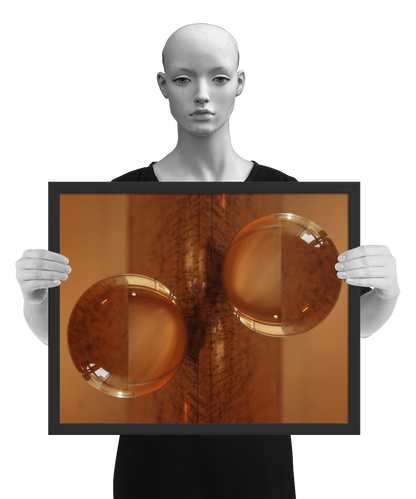 un4rt - the photographie is doubled and then mirrored. both photographies together create the final image. the photographie shows a glass ball on a wooden board. the wooden board is reflecting inside the glasball. the colors range from light brown to orange. the image is framed and presented by a mannequin in black and white.