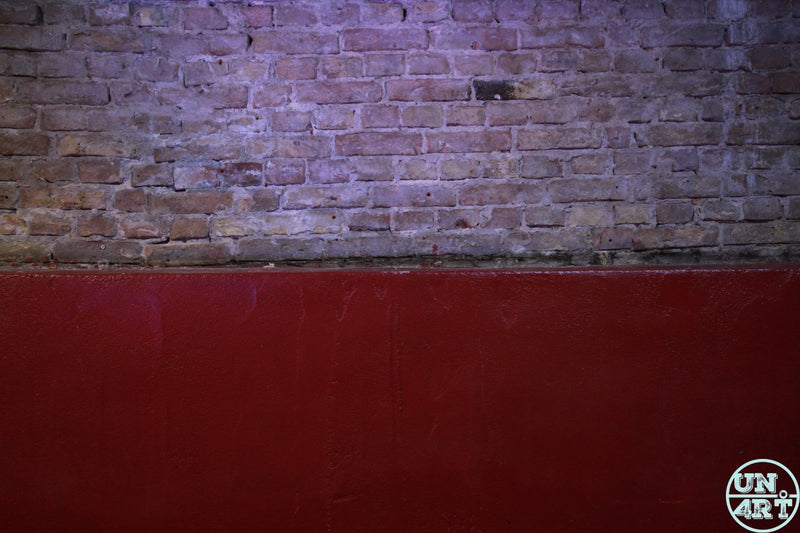 UN4RT imaginarium – aged red and purple tinted brick wall with bold colour contrast, dark urban texture photography.