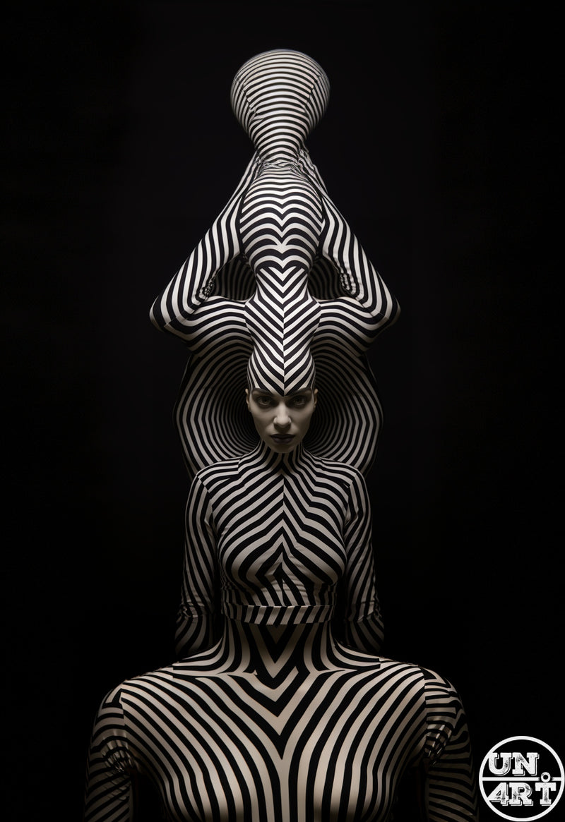 UN4RT imaginarium – female figure completely covered from head to toe in bold black and white optical illusion zebra stripes balancing a striped sphere overhead with unusual bodyparts ainst a pure black background, dark op-art body paint fine art photography.
