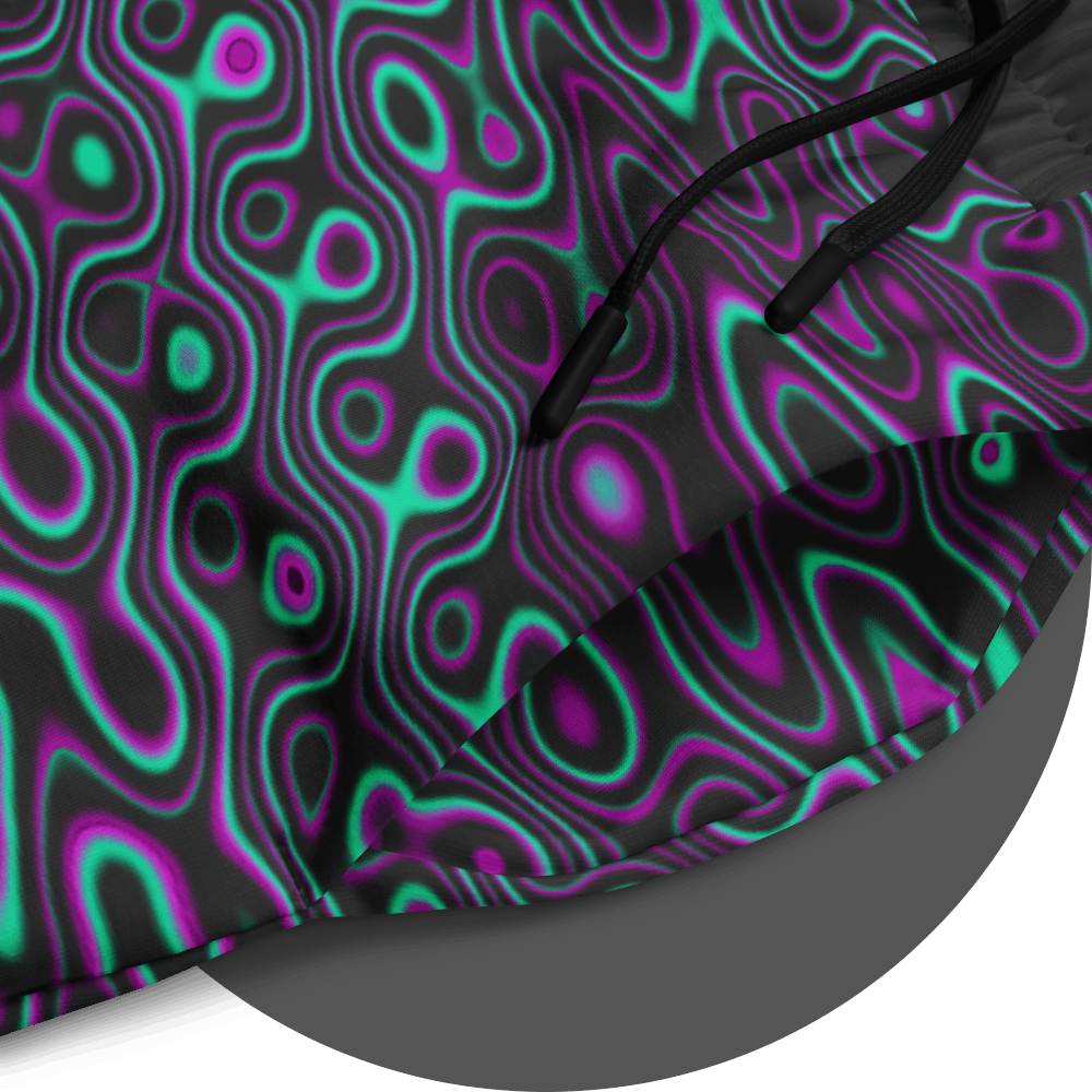 UN4RT liquification jogging pants fabric detail – close-up of all-over-print showing flowing neon turquoise and magenta liquid curves on black fabric, black drawstring visible at waistband, fine print quality showcased.