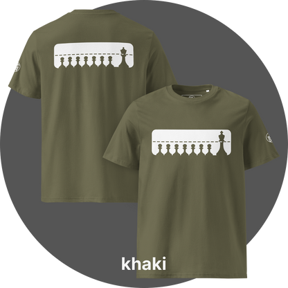 UN4RT khaki organic cotton t-shirt shown from the front and back, both sides featuring a large white rectangular graphic with a row of eight black chess pawns standing below a dashed horizontal line. a taller black chess king (front side) / queen (back side) standing at the far right, small circular brand logo visible on both left sleeves.