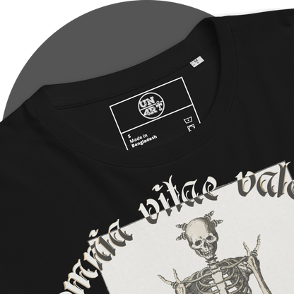 UN4RT black organic cotton t-shirt close-up detail of the inner neck area, showing the UN4RT brand label printed in white  inside a rectangular border. care instruction symbols. the gothic blackletter text "omnia vitae valent" and upper skull of the skeleton illustration partially visible below.