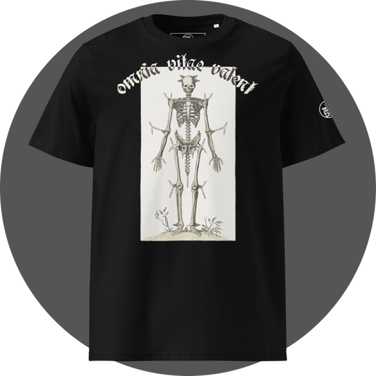 UN4RT black organic cotton t-shirt shown from the front, featuring a large off-white rectangular vintage anatomical illustration of a full human skeleton with small horns on the skull standing upright with small plants at the feet, arched gothic blackletter text reading "omnia vitae valent" above, small circular brand logo on the left sleeve.