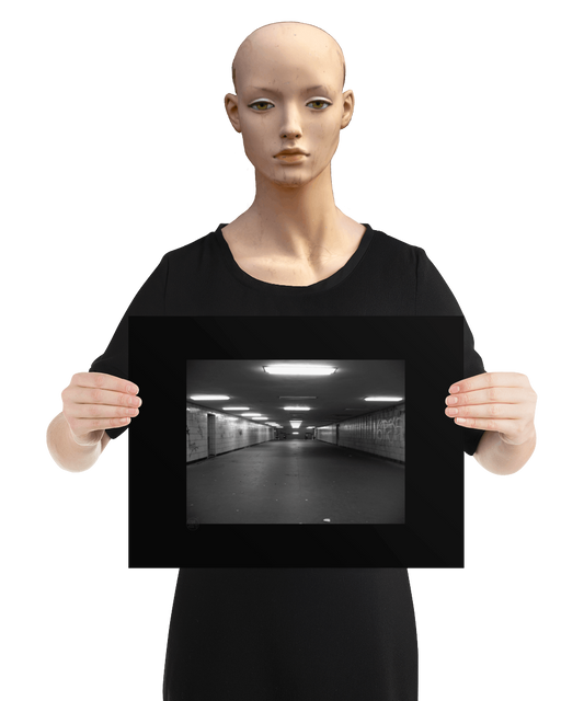 un4rt - a black and white photographie of a former underground trespas that once was part of the train station "alexanderplatz in berlin. graffities on the walls, trash on the ground. the image is held by a mannequin.