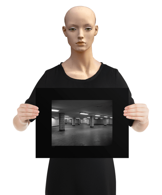 un4rt - a black and white photographie of a former underground trespas that once was part of the train station "alexanderplatz in berlin. tiled square columns support the ceiling. graffities on the columns and the ceiling. the image is held by a mannequin.