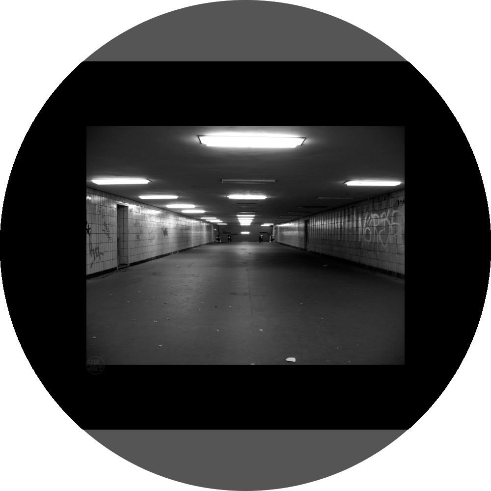 un4rt - a black and white photographie of a former underground trespas that once was part of the train station "alexanderplatz" in berlin. graffities on the walls, trash on the ground.