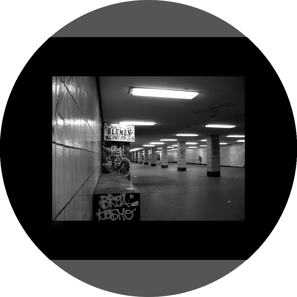un4rt - a black and white photographie of a former underground trespas that once was part of the train station "alexanderplatz" in berlin. tiled square columns support the ceiling. the left wall also has a porch of an old flower shop. the porch is full of graffities and the sign of the shop advertises "blumen".