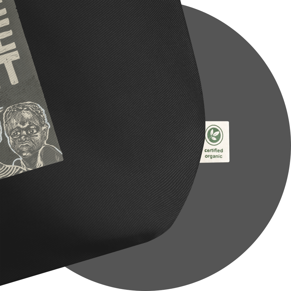 un4rt - the image shows details of a black certified organic cotton tote bag with parts of a print. a white label is attached to the tote bag. the print n the label reads: "certified organic".