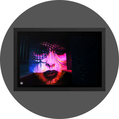 un4rt - the photographie shows a mural of a female face in various colors, pink, yellow, blue, orange. the face is surrounded by black walls, some made of bricks, some made of wood. 