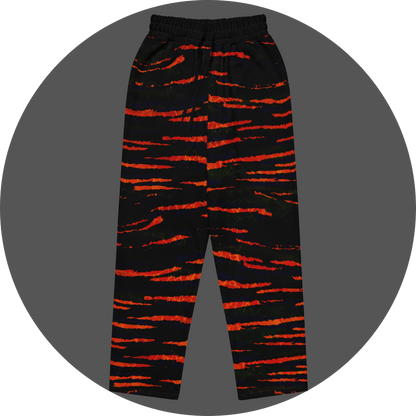 UN4RT tiger lily all-over-print jogging pants front flat – black sweatpants with bold fiery orange-red horizontal tiger stripe pattern across entire surface, elasticated waistband with drawstring.