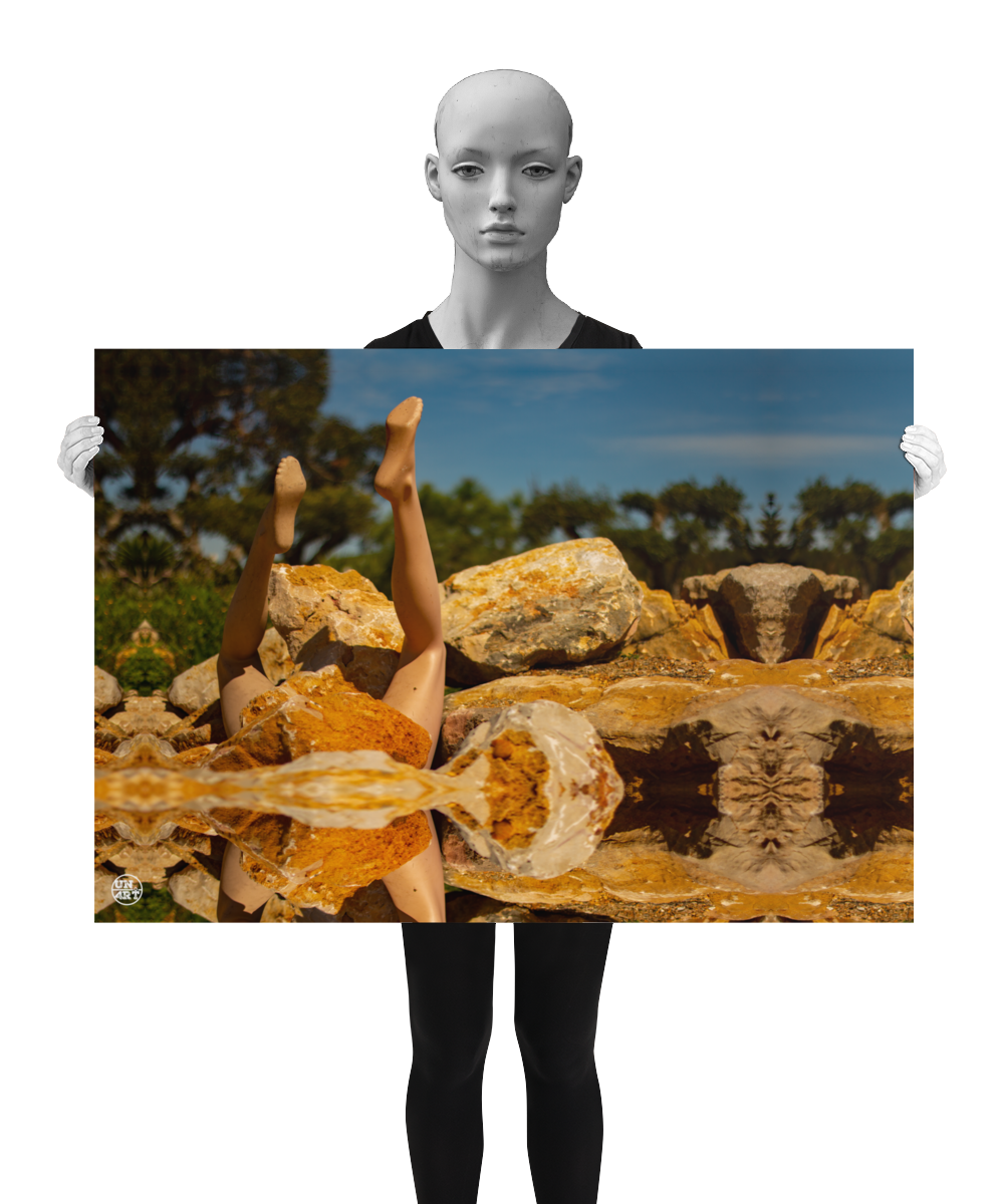 un4rt - a photographie that is mirrored on all sides. the image shows the legs of a mannequin which seems to be stuck upside down in a mountain of stones. some old olive trees and a blue sky with a few white clouds in the background. the background is unfocused. the image is shown by a mannequin in black and white.