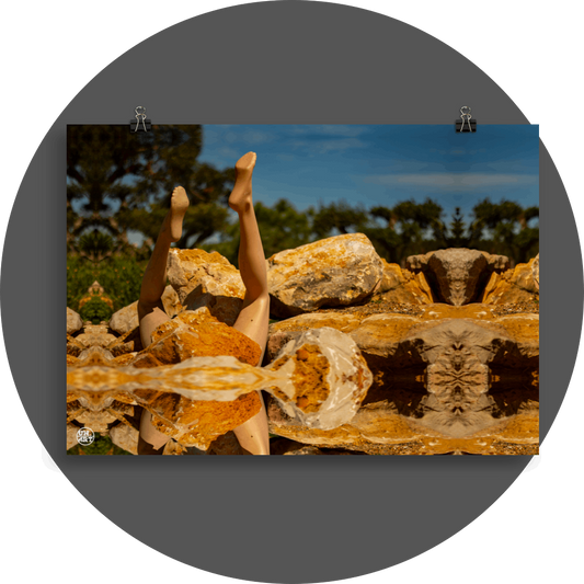 un4rt - a photographie that is mirrored on all sides. the image shows the legs of a mannequin which seems to be stuck upside down in a mountain of stones. some old olive trees and a blue sky with a few white clouds in the background. the background is unfocused.