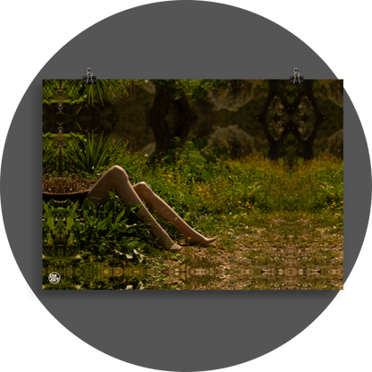 un4rt - a photographie that is mirrored on all sides. the image shows the legs of a mannequin which seems to be stuck under an old bath tub. wild greenery everywhere around. some old tree trunks in the background. unsharp background.