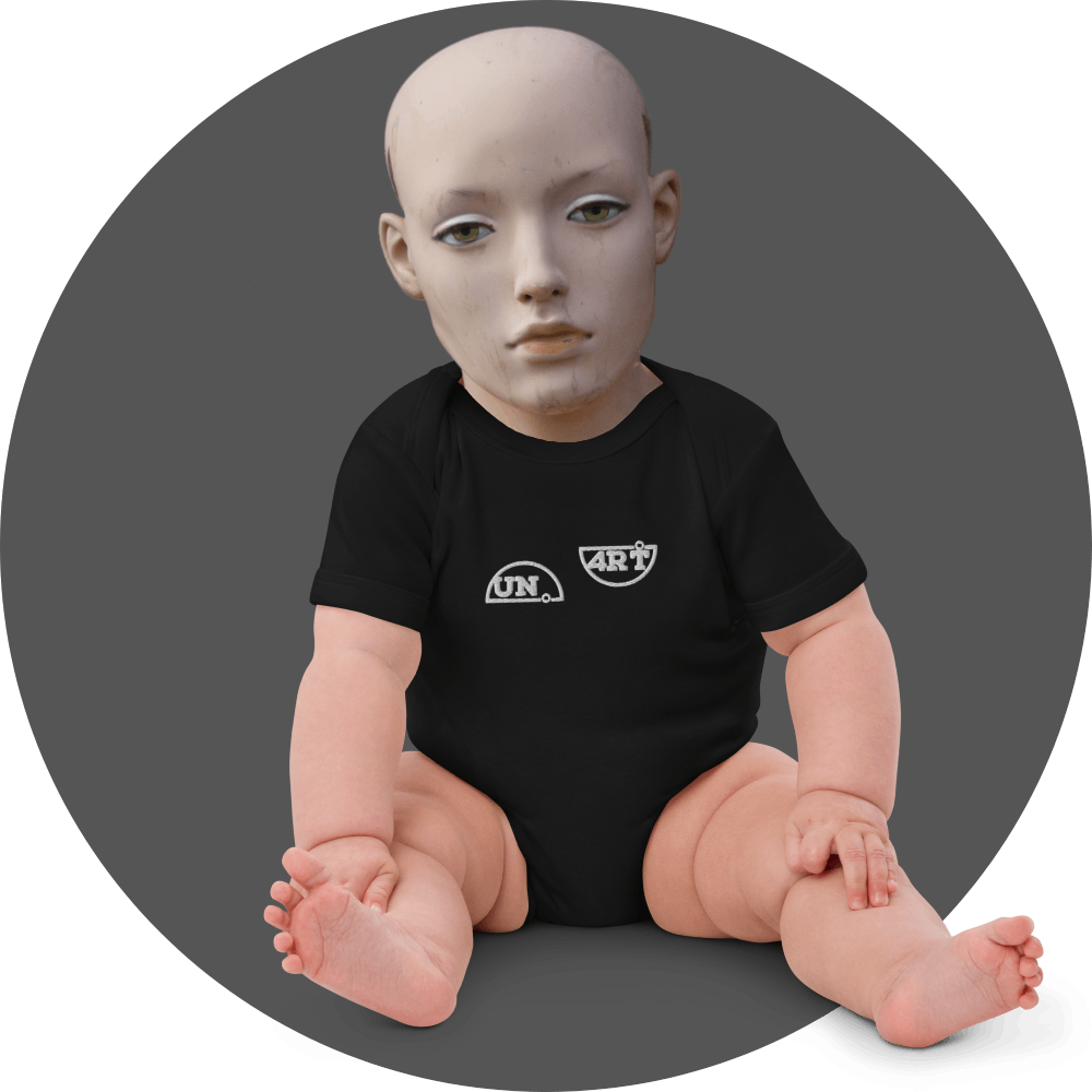 UN4RT black baby bodysuit, small white "UN." semicircle logo and "4RT" semicircle logo side by side on chest, short sleeve, snap closure, baby mannequin seated front view, grey circular background.