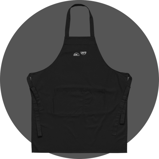 un4rt - the images shows a black apron with white embroidery of a splitted "UN4RT"-logo. 