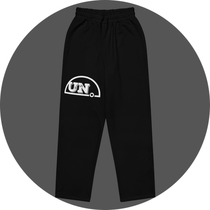 un4rt - the image shows the front of a black jogger pant with a white print of the upper part of the "UN4RT"-logo on the right leg.
