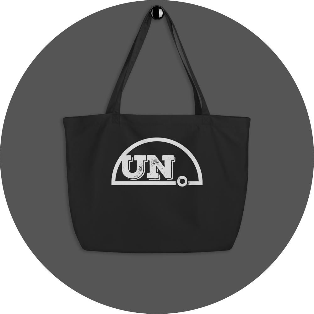 un4rt - the image shows a black certified organic cotton tote bag with a big white print of the upper part of the "UN4RT"-logo on it.